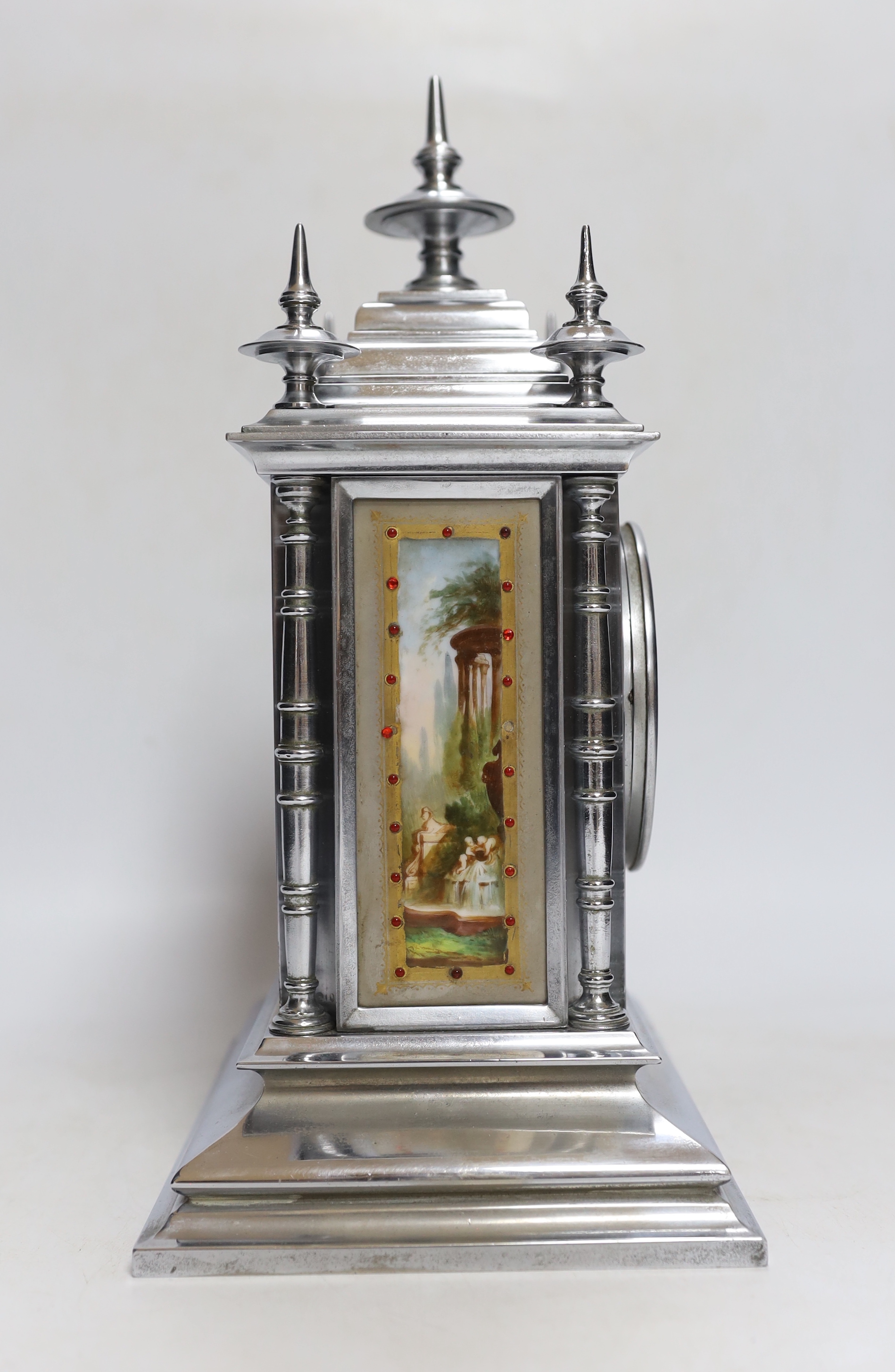 A French chrome plated mantel clock, with jewelled porcelain inset panels 32cm